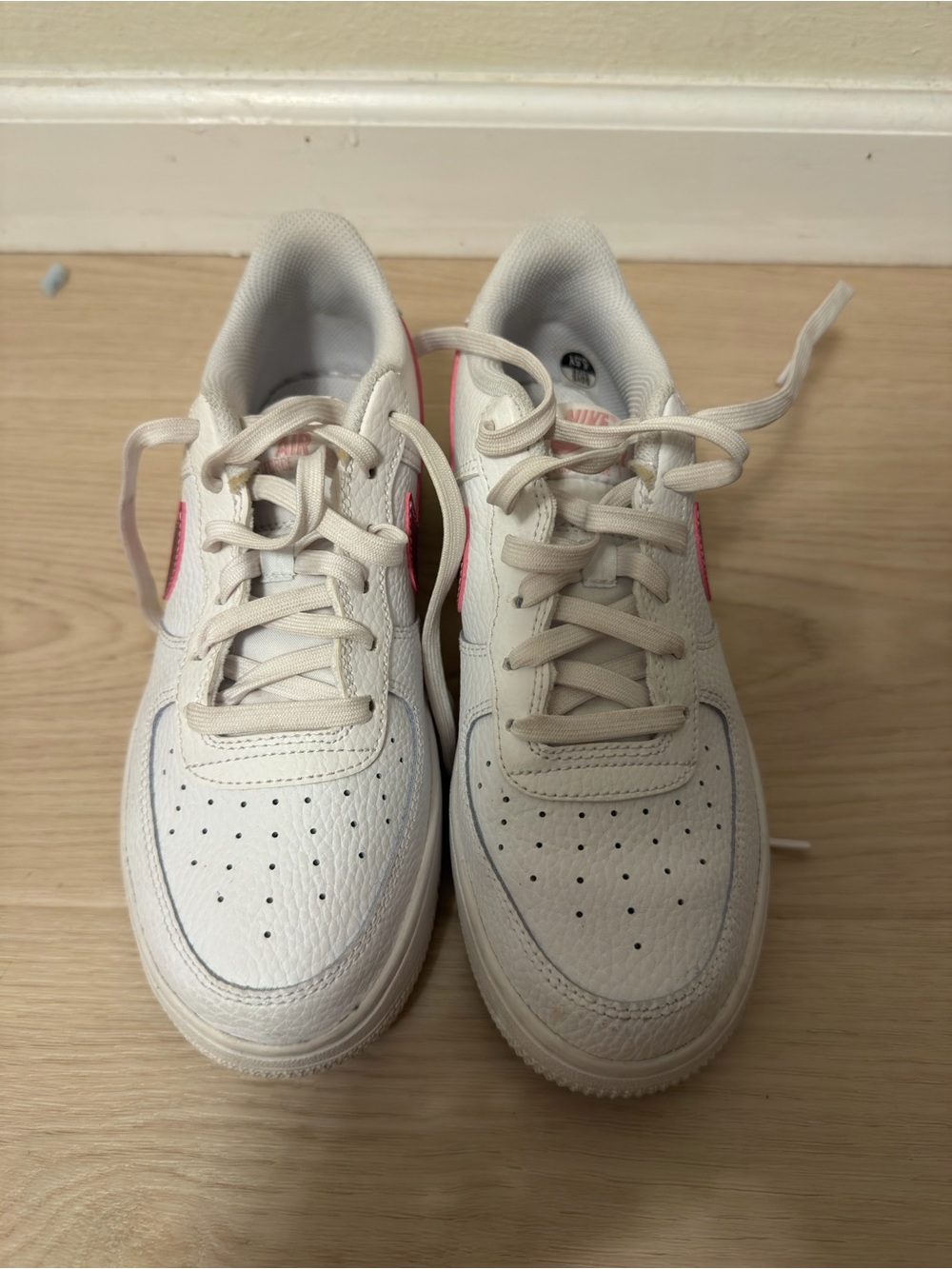 Nike White Sneakers with Pink Swoosh Accent